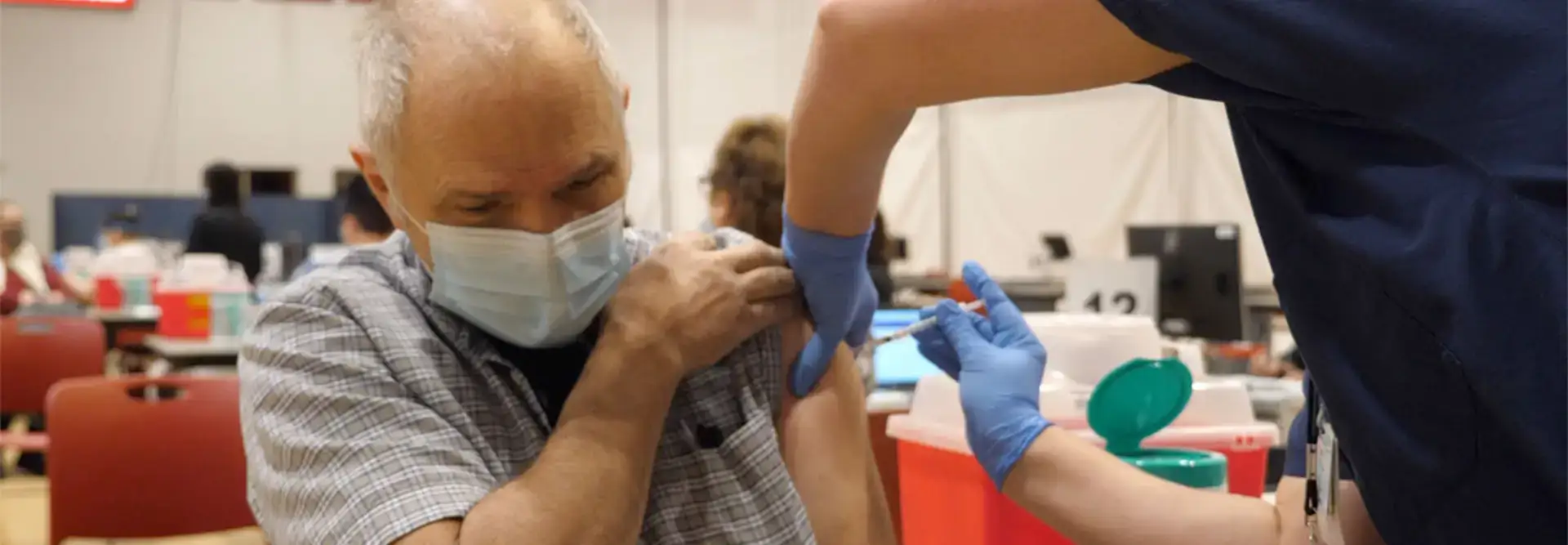 Community member getting COVID shot at state vaccination center on SUNY Oneonta campus