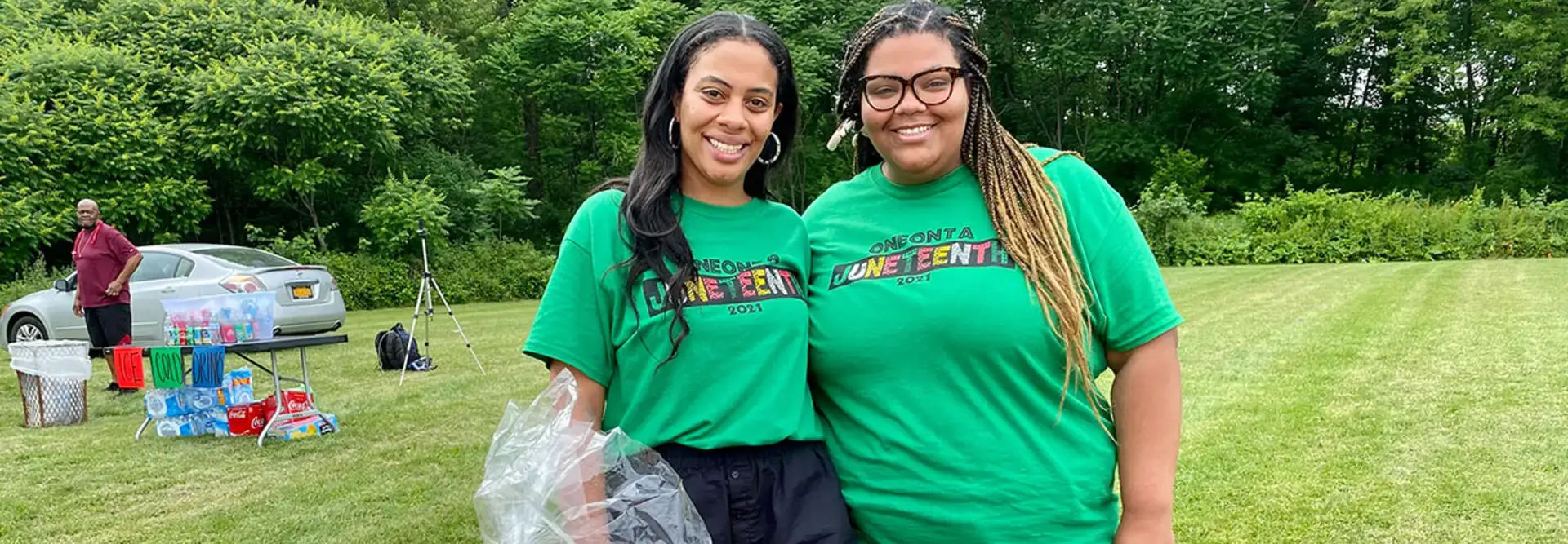 Sierra Sangetti-Daniels, left, and her sister, event creator Diandra Sangetti-Daniels, stand near the raffle basket table during the Juneteenth event.