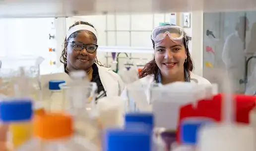 Two students posing for a photo in a chemistry lab.