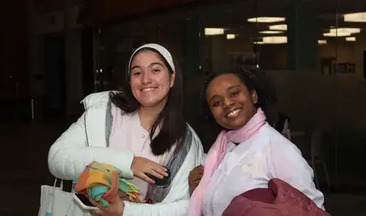 Two smiling students posing for a photo together