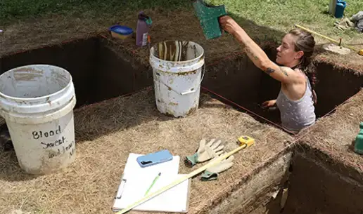 Archaeology student digs for artifacts