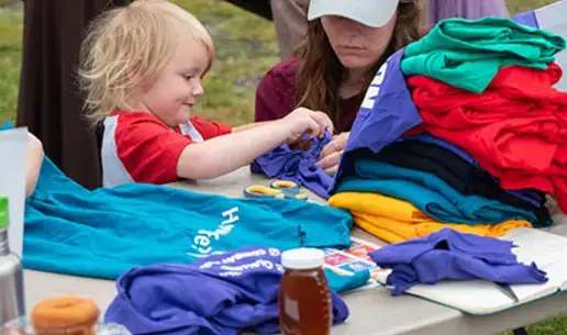 Child being assisted at the Farmers Market