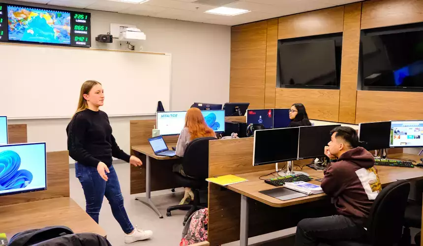 Accounting students discuss the subject in one of the high-tech business school rooms.