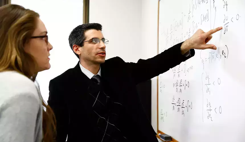 Philip Sirianni, assistant professor of economics, meets with student Mariel Doyle to discuss her research project