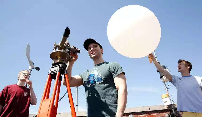Meteorology students practice launching a weather balloon