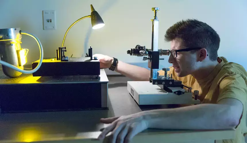 Student uses optical tools in physics lab