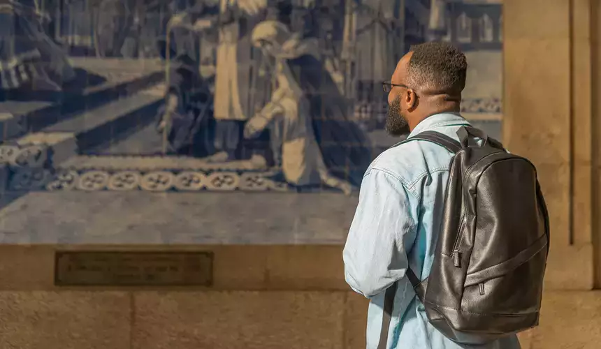 African American individual looking over artwork