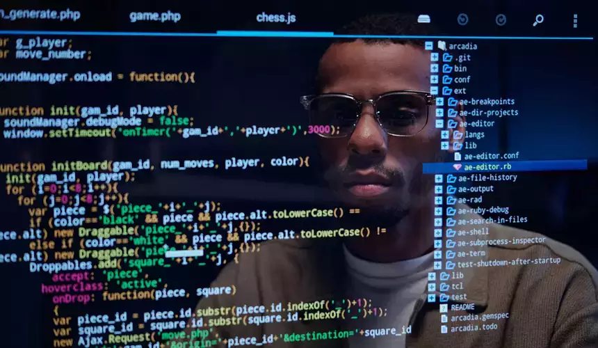 Computer science majors reflection on screen while programing code