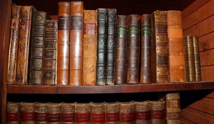 Old books on a shelf at the Hyde Hall Historical site. 