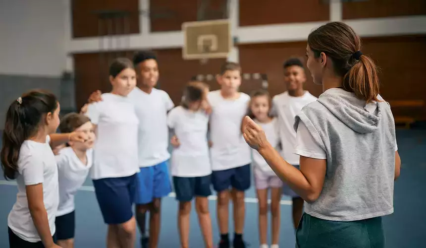 A coach speaks to her class during physical education