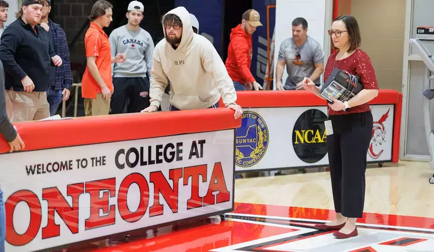 Students in a Sports Management class setup for an upcoming basketball event.