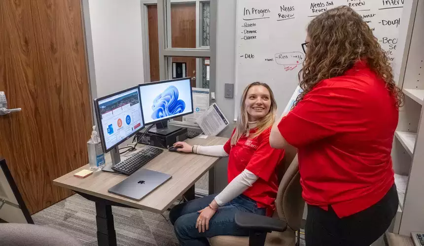 Volunteers discuss income tax assistance