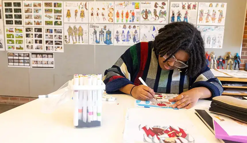 A student works on sketches during an illustration class.