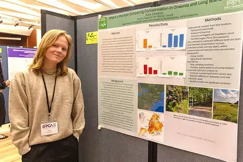Kate Edwards stands next to her SRCA research poster