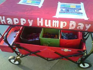 Red wagon with the words Happy Hump Day on the top of it