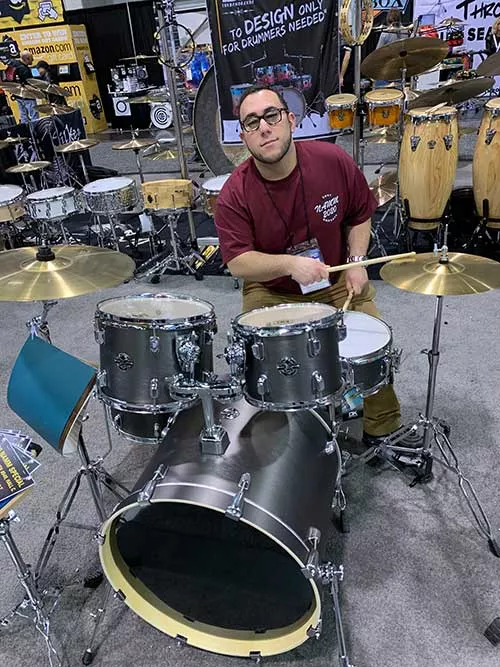 Ryan Mastrelli tests out a drum set. 