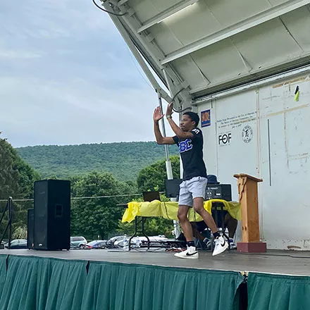 SUNY Oneonta senior Shawn Robinson, a member of the Beta Beta Pi Chapter of Phi Beta Sigma Fraternity, Inc., performs on stage during the Juneteenth celebration. 