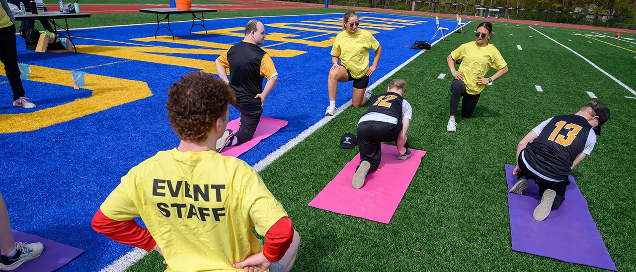 Students helping athletes prepare for the special Olympics.