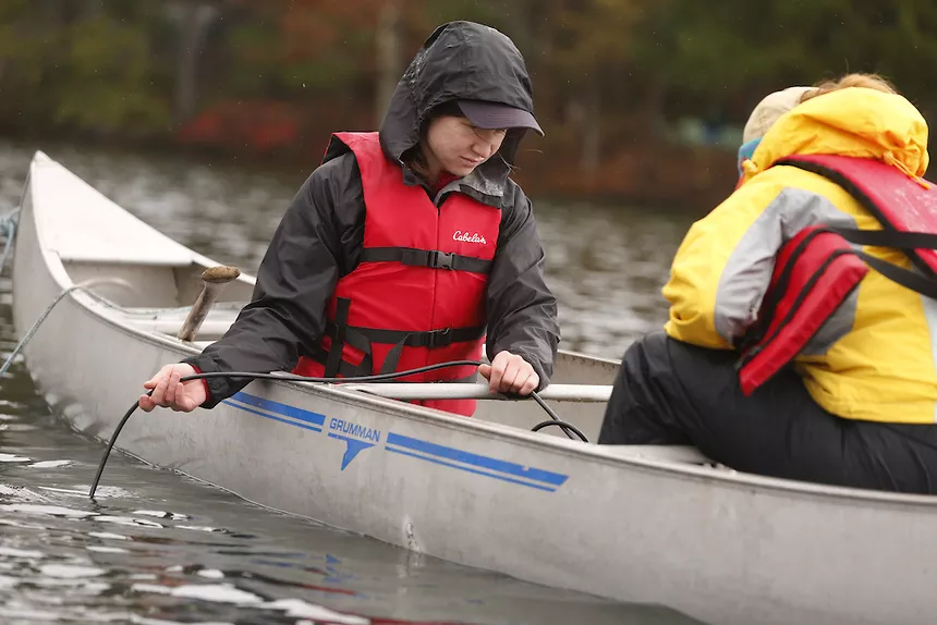 Lake Management students riding in a canoe on a lake.