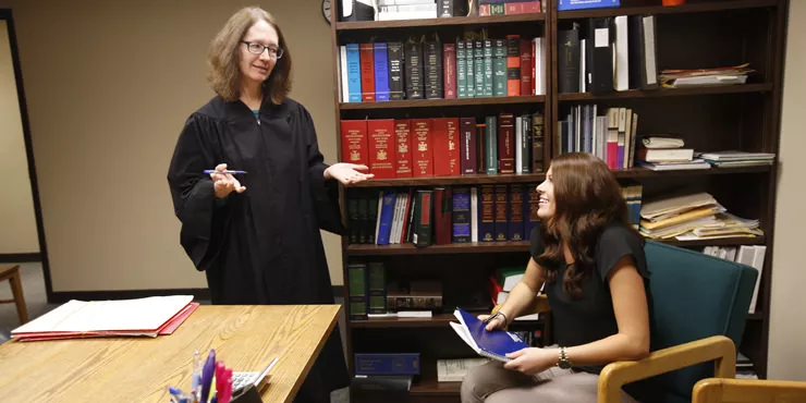 Criminal justice major Alexis Bolesky confers with Judge Lucy Bernier during an internship at Oneonta City Court.