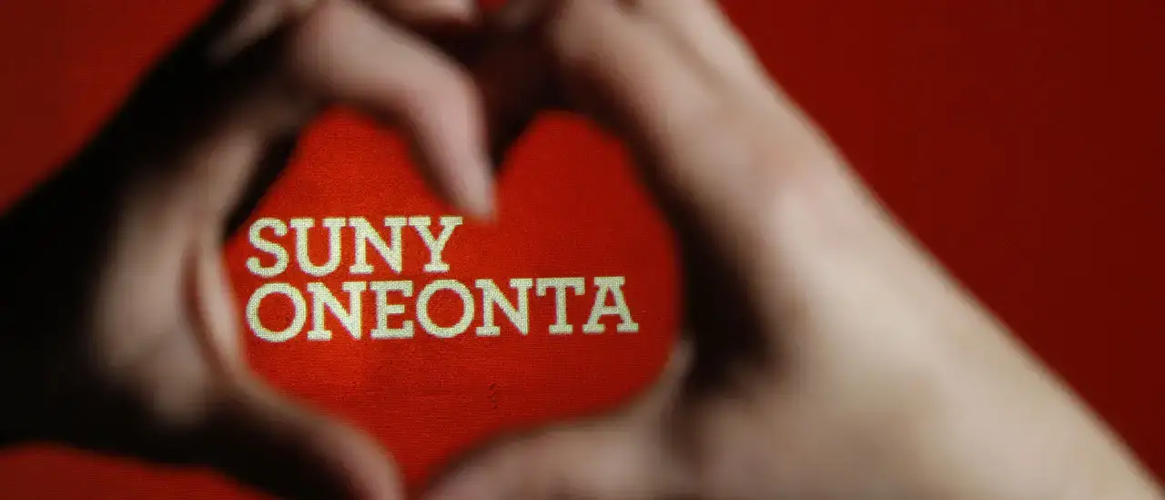 hands making a heart with "SUNY Oneonta" in the background