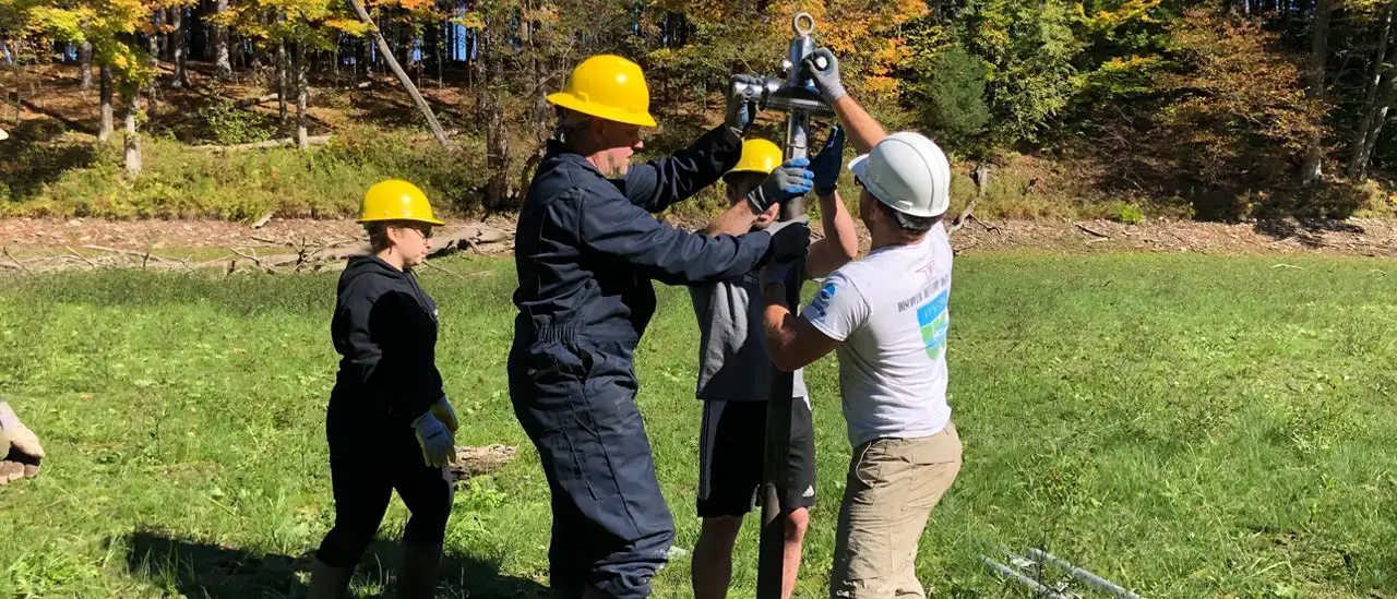 Geology students and faculty coring into muds of Lower Reservoir while drained