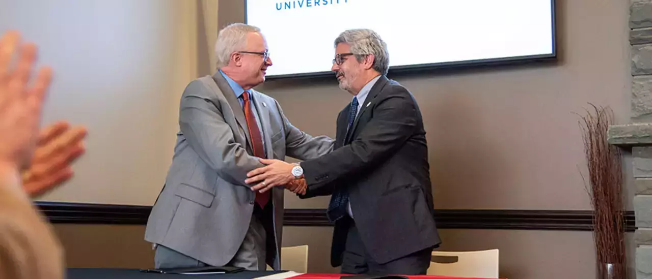 Nursing Student Pathway with Utica University Shaking Hands