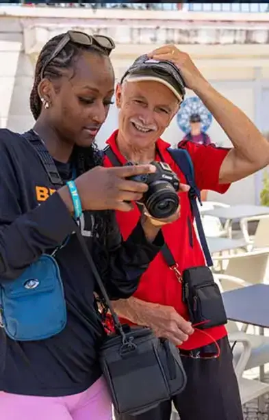 Student showing a man her photo in Portugal 