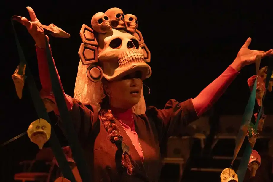Performing with a skull headdress in the Curzando Ensuenos performance