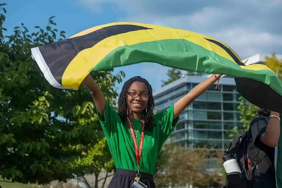 Student waves their flag during the Parade of Nations