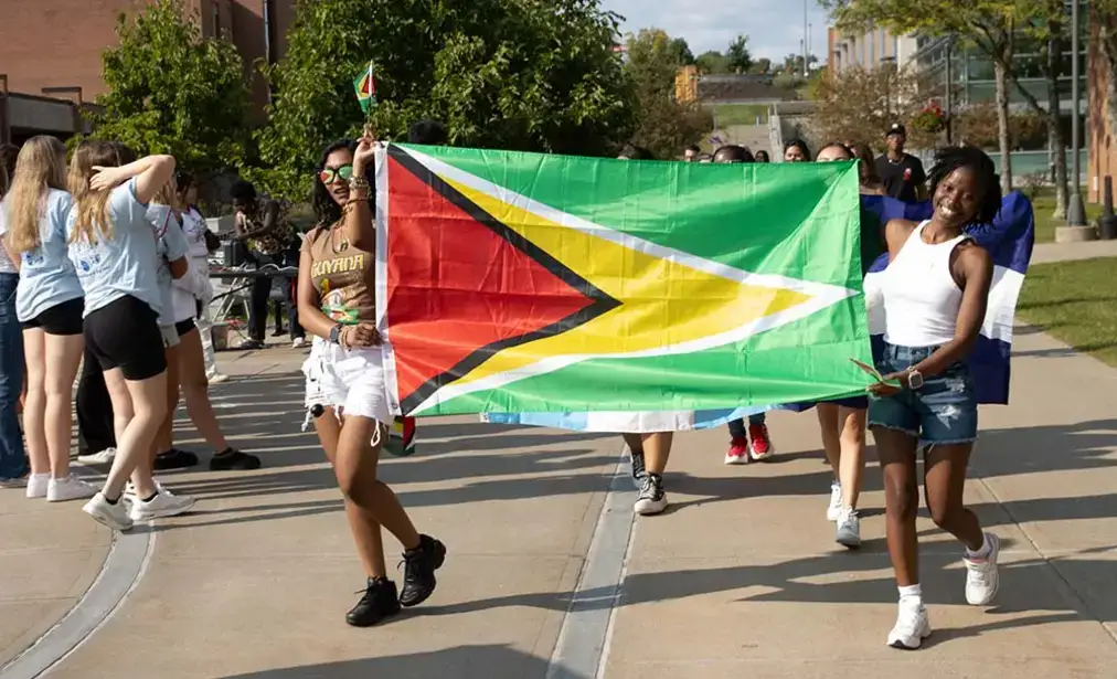 Students proudly display their flag during parade of nations