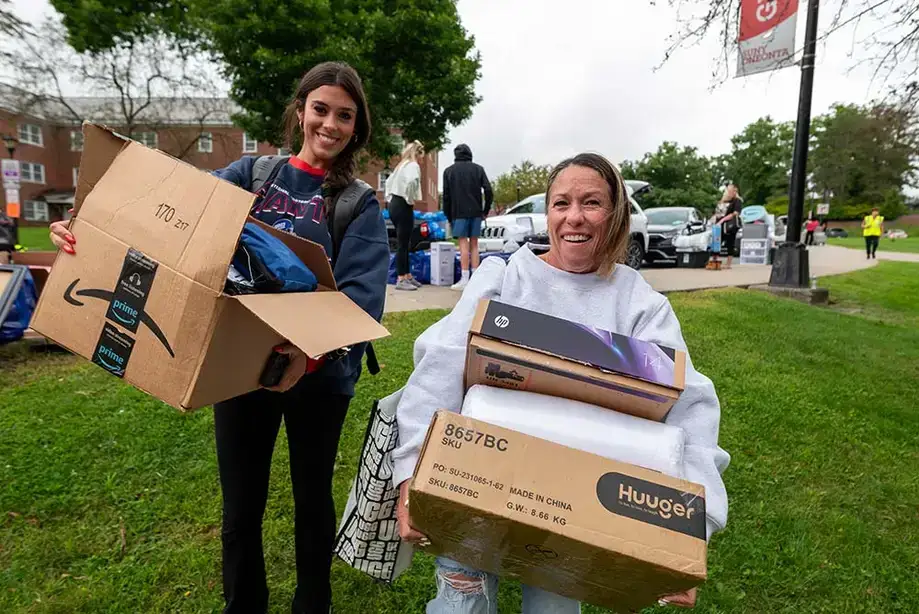 Happily carrying big boxes during move-in