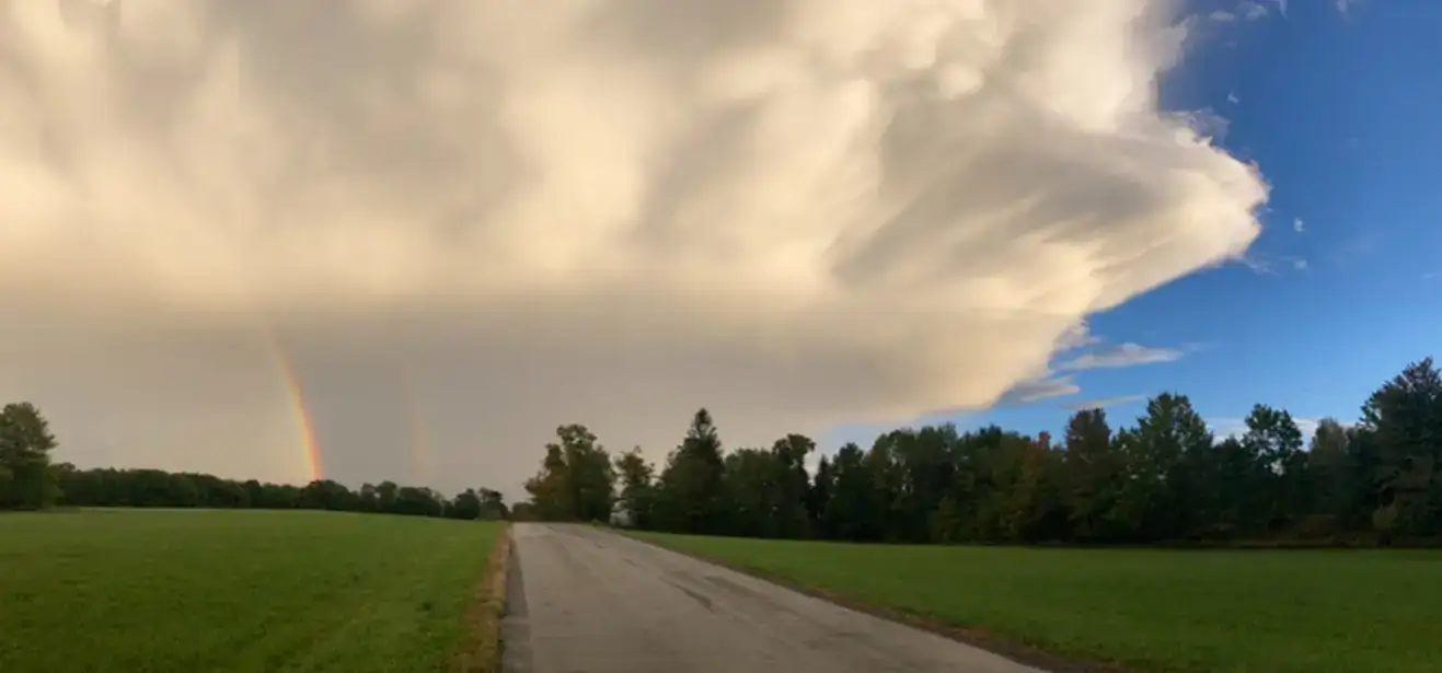 Departing supercell with double rainbow in Treadwell, NY
