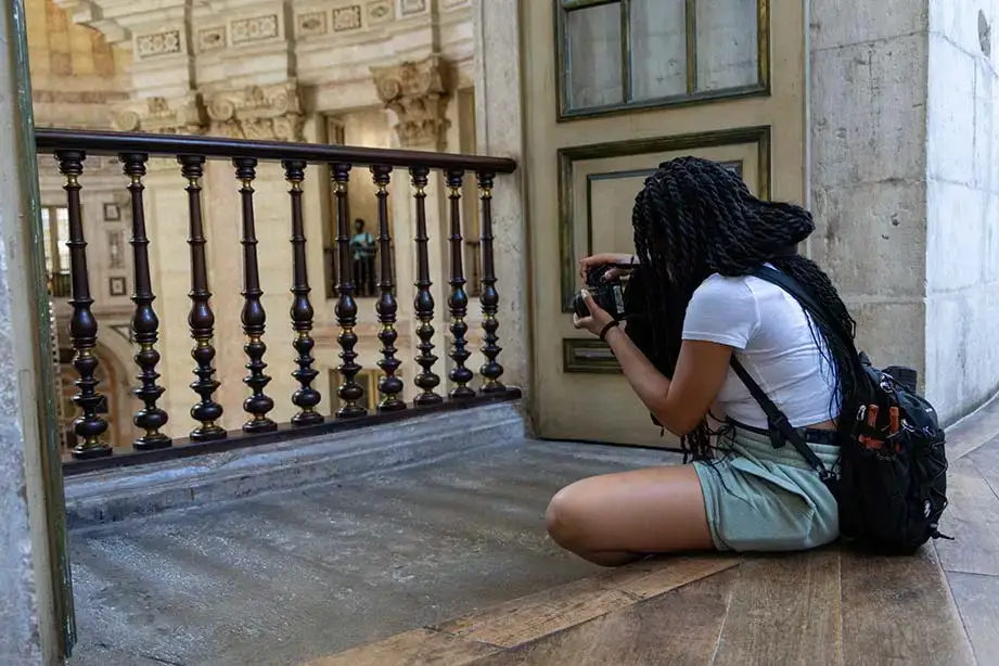 A student takes a photo from a balcony in Portugal.