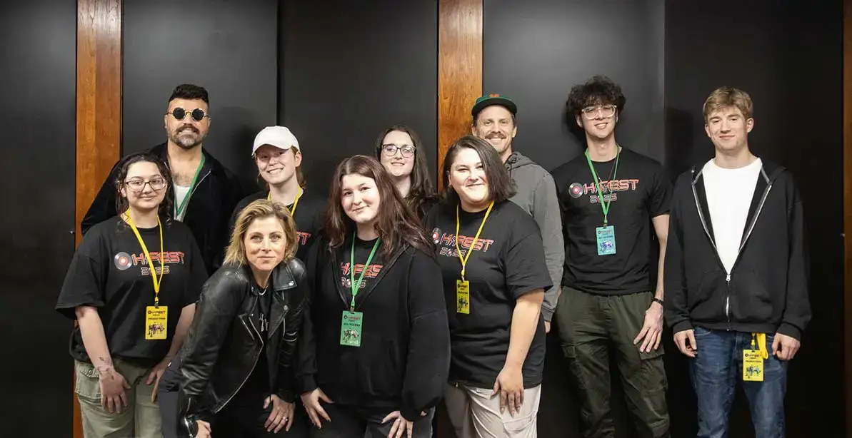 Oh-Fest 2025 headliners Neon Trees pose backstage with student volunteers.