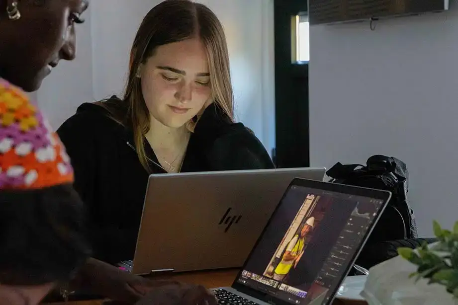 Students review their photography on laptops.