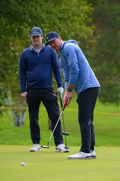 A contender watches as their putt travels toward the hole at the Red Dragon Open.
