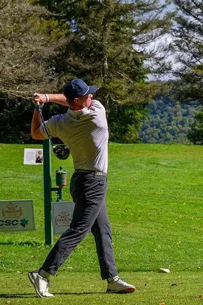A contestant stands tall as they finish their swing teeing off at the Red Dragon Open.