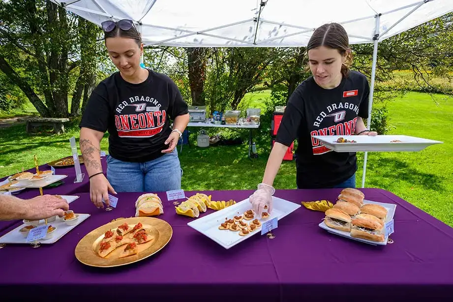 Volunteers put out food for the contestants at the Red Dragon Open.