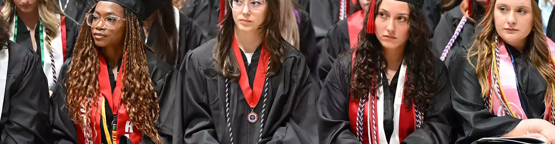 Students listen intently to a speech during 2025 Spring Commencement
