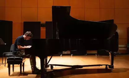 A music major student plays a grand piano as part of the 2024 fall concert