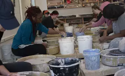 Students take part in a wheel throwing class and glazing demonstration.