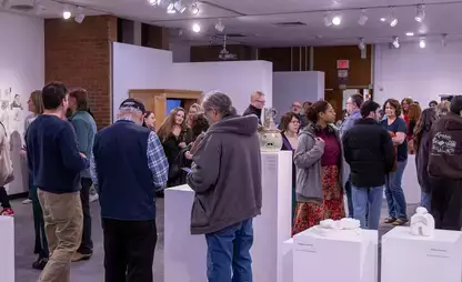 Patrons and students mingle during the juried student art show.