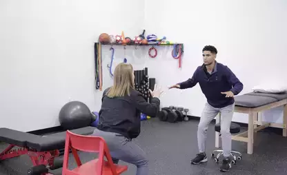 Dr. Chelsea Leah of Connect Physical Therapy demonstrates technique to intern Graham Wooden