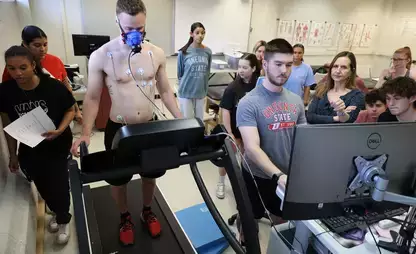 Assistant Professor Lisa M Rusch of the Department of Sport and Exercise Sciences works with students in the lab