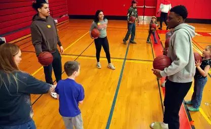 Exercise science students work in the EDD adaptive sports basketball clinic