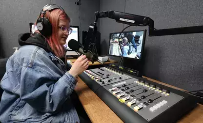 A student works the soundboard at 90.9 FM, WONY