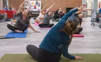 Yoga instructor facing practicing students