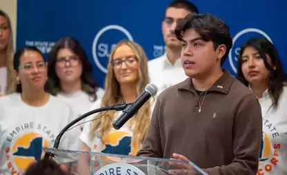A student speaking at an announcement/celebration of SUNY Oneonta&rsquo;s record participation in the Empire State Service Corps program.
