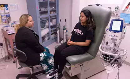 An on-campus health provider speaks with a student in the Health and Wellness Center